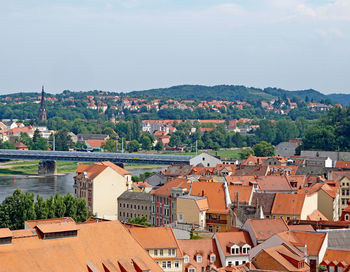 High angle view of houses in town against sky