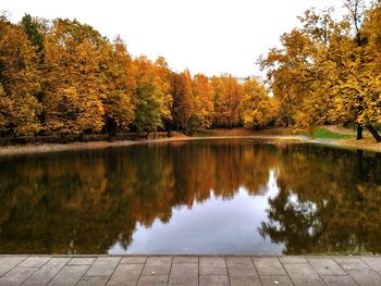 Reflection of trees in lake against sky during autumn