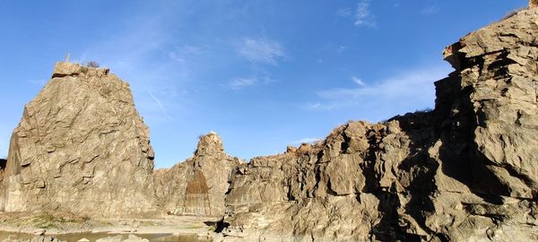 Low angle view of rocks against sky