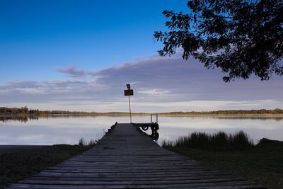 Scenic view of pier on lake against sky