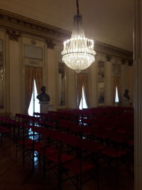 Illuminated chandelier hanging in building