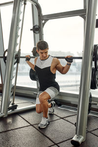 Portrait of young man exercising in gym