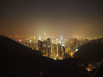 High angle view of illuminated cityscape seen from mountain at night