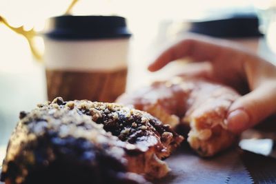 Close-up of hand holding donut