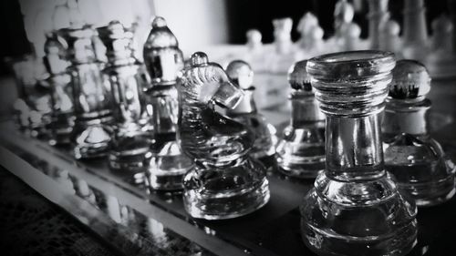 Close-up of glass chess pieces on table