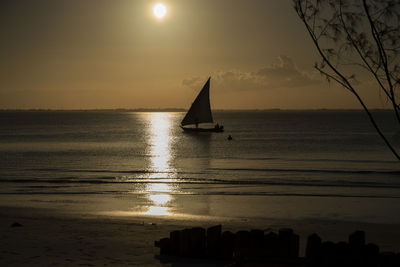 Silhouette sailboat on sea against sky during sunset