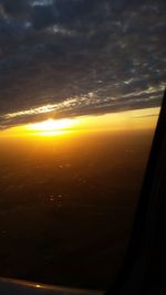 Scenic view of sunset seen through airplane window