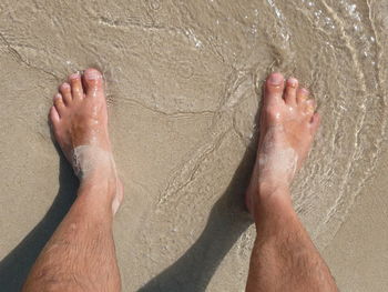 Low section of man legs on beach