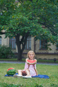 Portrait of a smiling young woman sitting outdoors