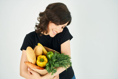 Woman holding apple against white background