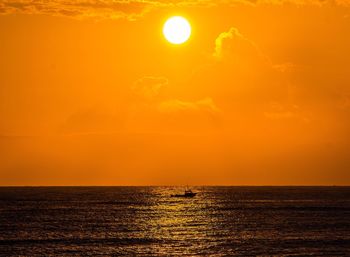 Scenic view of sea against orange sky