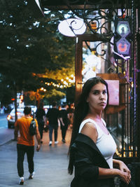 Portrait of young woman in city