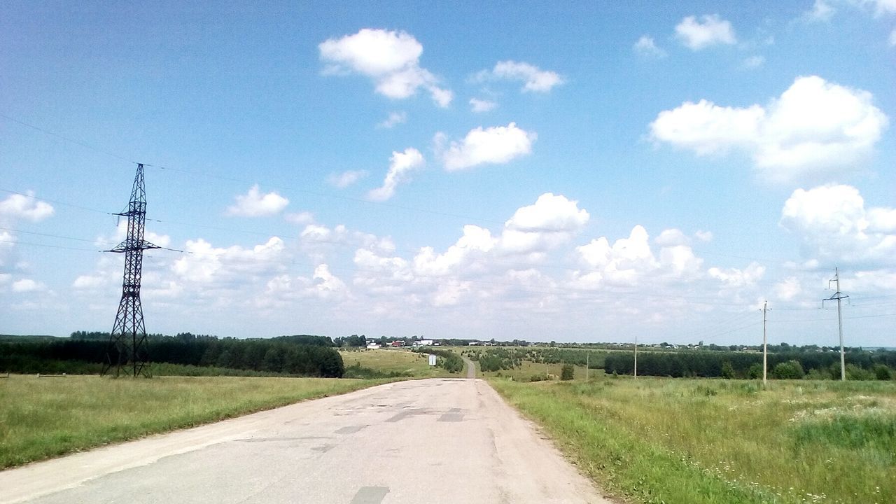 ROAD PASSING THROUGH FIELD AGAINST SKY