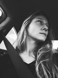 Portrait of beautiful young woman in car