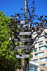 Low angle view of road sign against clear sky