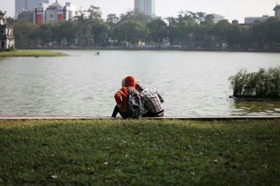 Man sitting on bench in river