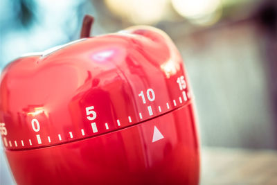 Close-up of red apple shape container on table