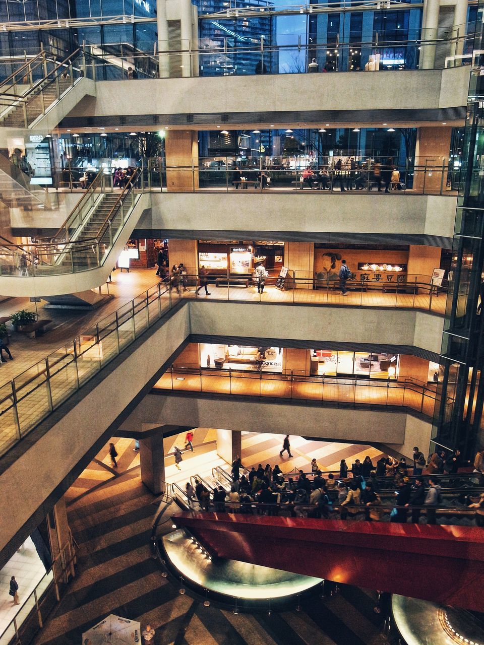 architecture, built structure, building exterior, city, business, illuminated, table, group of people, food and drink, high angle view, window, restaurant, real people, large group of people, incidental people, glass - material, reflection, modern, night