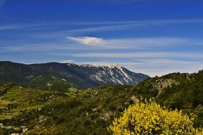 Scenic view of mountains against blue sky