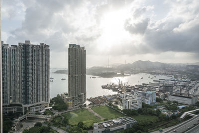 High angle view of city against cloudy sky