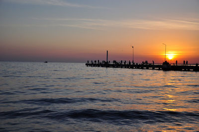 A pier into the sea during dawn