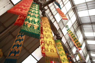 Low angle view of decorations hanging on ceiling of building