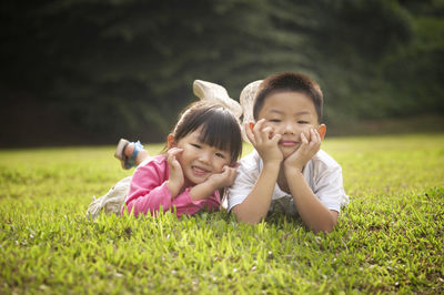 Playful sibling on field at park
