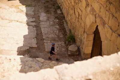 Man walking by historic building