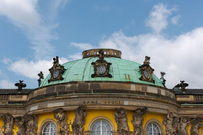 Low angle view of historical building against cloudy sky