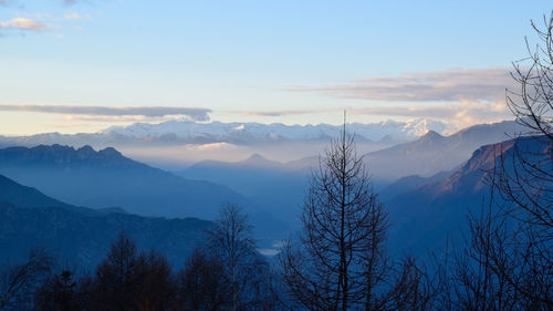 Scenic view of snowcapped mountains against sky during sunset