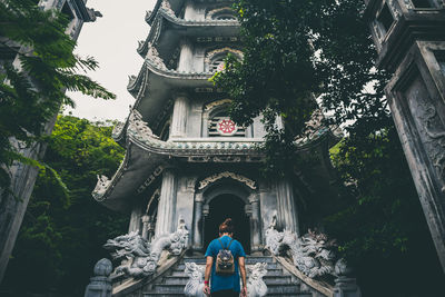 Low angle view of man standing against building