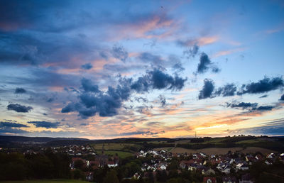 High angle shot of townscape against sky at sunset
