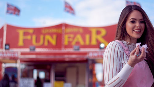 Portrait of a smiling young woman in amusement park