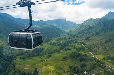 View of overhead cable car against mountains