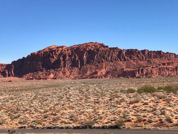 Scenic view of rocky mountains against clear blue sky