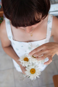 Close-up of woman holding flower