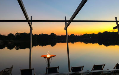 Scenic view of lake against sky at sunset