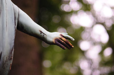 Close-up of hand of rusty statue in park