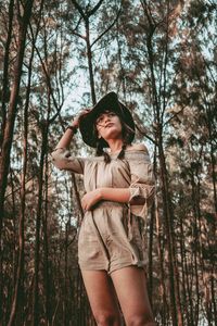 Young woman standing in forest