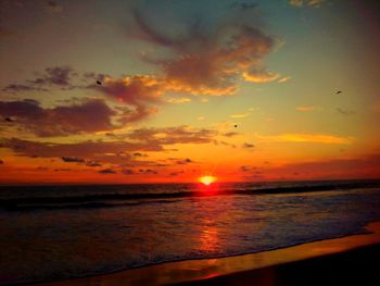 Scenic view of sea against romantic sky at sunset