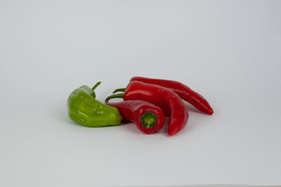 Close-up of chili peppers against white background