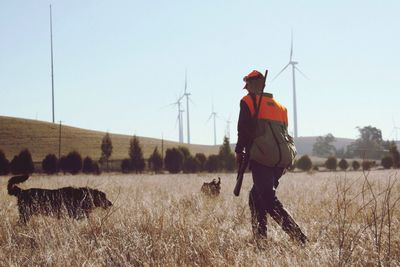 Hunter with two dogs in field