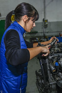 Side view of man working in workshop