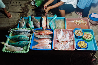 High angle view of people and fish on table