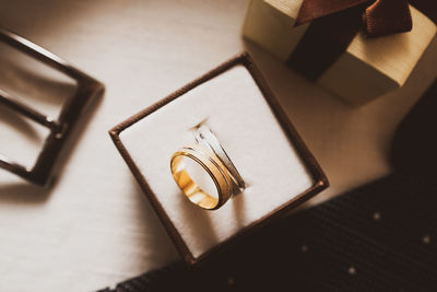 Close-up of wedding rings on table