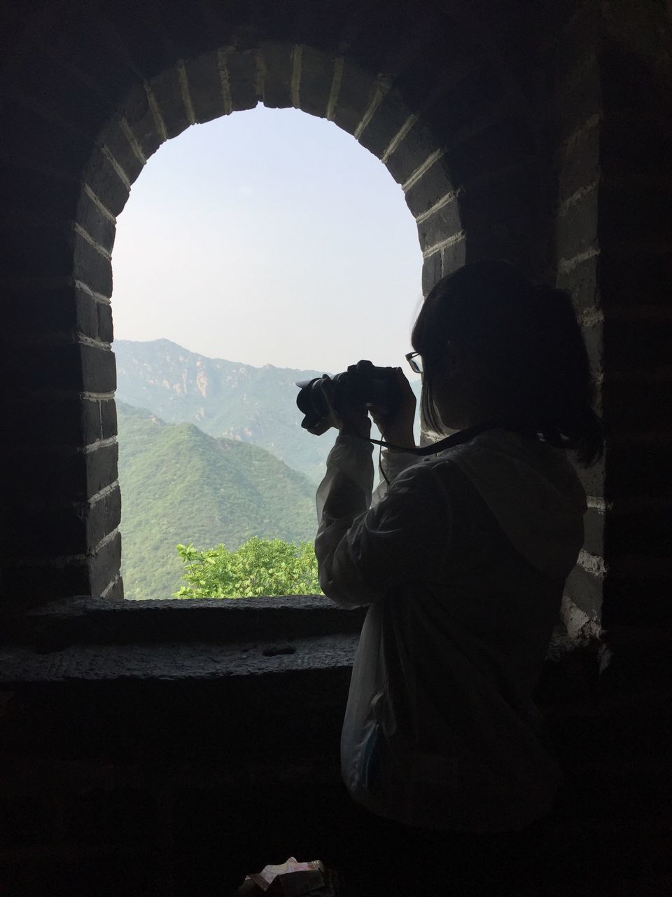 lifestyles, mountain, indoors, rear view, men, leisure activity, standing, silhouette, full length, looking at view, person, tranquility, tranquil scene, landscape, sky, nature, copy space, mountain range