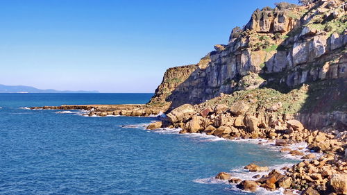 Scenic view of sea against clear blue sky