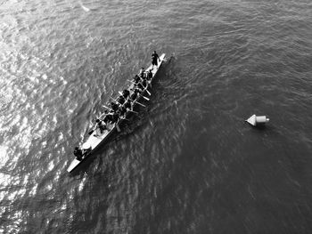 High angle view of people rowing boat on sea 