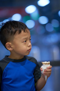 Close-up of boy eating ice cream outdoors