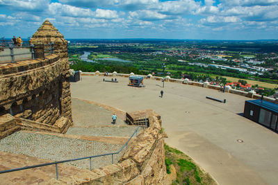 High angle view of city by sea against sky